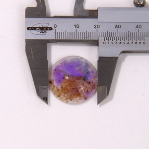 Macro shot of 20mm round resin cabochon with purple sand texture and measurement