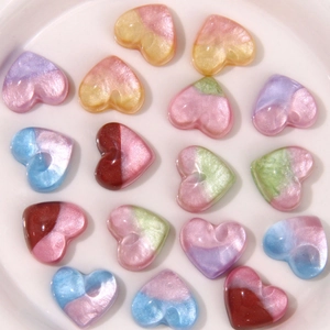 Close-up of gradient heart resin charms with pearlescent finish for DIY jewelry