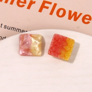 Macro view of square resin earrings with summer water ripple and marble glitter textures