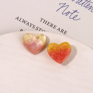 Macro shot of gradient starry heart resin charms with marble texture for DIY jewelry