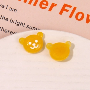 Close-up of cute yellow resin bear charms for DIY jewelry and hair accessories craft