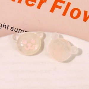 Macro shot of cute cartoon bear resin charms for DIY jewelry and phone case crafts