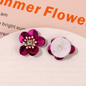 Macro detail of aurora coral sequins flower charms with crystal center for DIY crafts