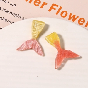 Close-up of glitter gradient resin mermaid tail charms for DIY shoe decoration