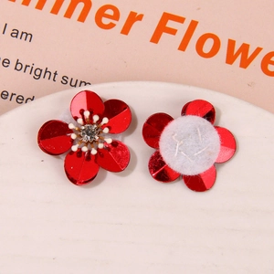 Close-up of red sequin flower accessory with crystal center and felt back for DIY