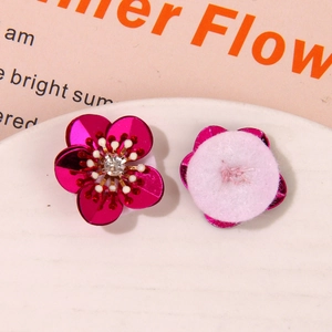 Detail view of aurora coral flower patches with crystal center and felt backing