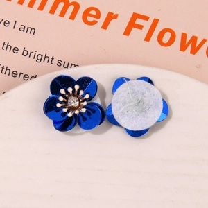 Detailed macro view showing the front and back of aurora coral sequin flower accessories