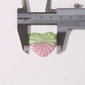 Glitter resin heart charm measured with a caliper showing approximately 27mm width