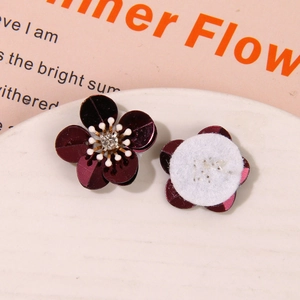 Close-up of purple sequin flower with rhinestone center and white felt backing DIY accessory