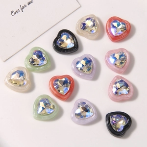 Macro view of colorful heart-shaped resin charms with faceted crystal rhinestones