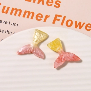 Close-up of glittery gradient resin mermaid tails for DIY jewelry and crafts