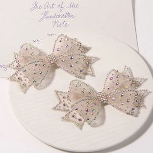 Detailed macro view of champagne mesh bows with iridescent rhinestones for hair accessories