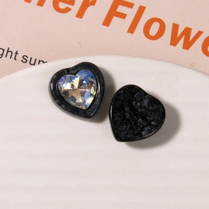Macro shot of 3D heart resin charms with holographic gems and matte black finish