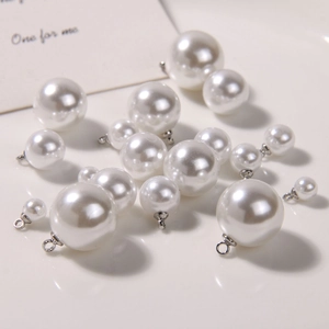 Minimalist white round pearl pendants in various sizes with silver loops for DIY jewelry