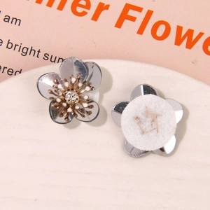 Macro shot of grey aurora sequin flowers with golden stamens and zircon centers