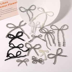 Handcrafted pearl bow shoe charms and DIY accessories for clogs on white tray