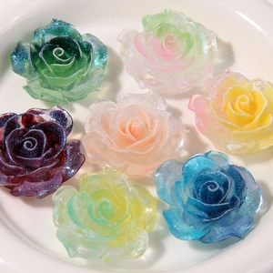 Detailed macro of colorful translucent resin roses with glitter for DIY craft accessories