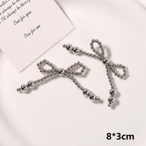 Detail view of 8x3cm handmade silver beaded bow accessory for DIY shoe decoration