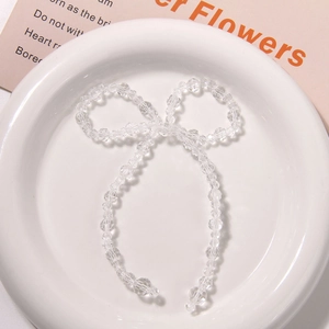 Close-up of transparent beaded crystal bow accessory for DIY handmade jewelry crafts