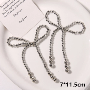 Detail of silver handmade beaded pearl bow shoe buckle accessories with tassel design