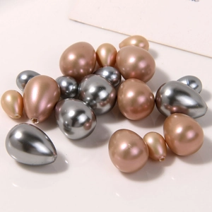 Macro shot of silver and rose gold water-drop faux pearl charms for DIY jewelry making