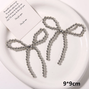 Detail view of 9x9cm silver pearl beaded bow shoe charms and handmade DIY accessories