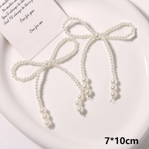 Detail view of a 7x10cm handmade pearl bow with tassels for DIY shoe decoration
