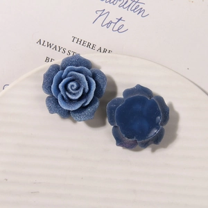Macro detail of blue sugar-coated resin rose charms for DIY jewelry and hair accessories