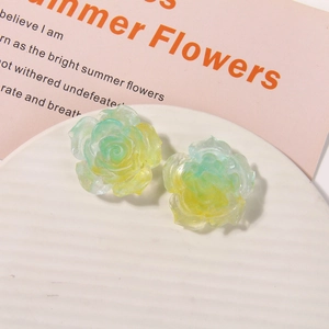 Detailed macro view of gradient yellow and green glitter resin rose flower charms