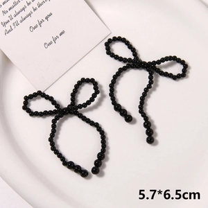 Detail view of handmade black pearl bow shoe charms for clogs, sized 5.7x6.5cm