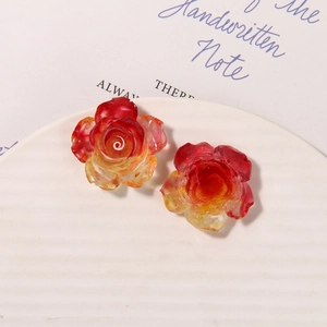 Macro shot of luminous resin rose charms with red and yellow gradient for DIY shoe buckles