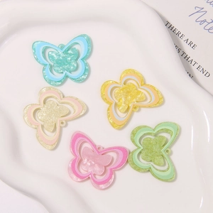 Macro shot of glittery acrylic butterfly charms in five colors for DIY shoe decoration