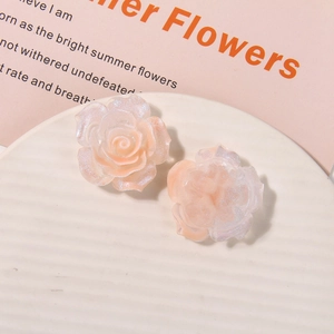Detail of rose-shaped resin flower with pearlescent glitter and gradient petal texture