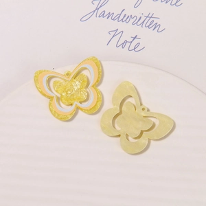 Macro shot of starry glitter butterfly charms for clogs with functional hanging holes