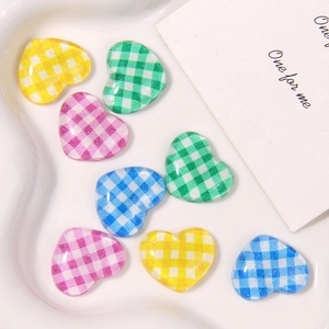 Colorful gingham heart resin flatback charms in yellow, green, pink and blue in a ceramic bowl
