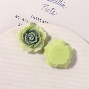 Detail of glitter resin rose charms with flat back for DIY jewelry and accessories