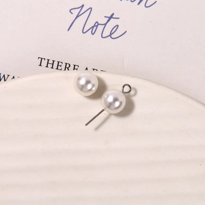 Macro view of matte glass pearls and silver metal pin components for DIY jewelry making