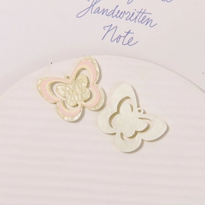 Detail of glittery acrylic butterfly charms with hanging holes for DIY shoe accessories