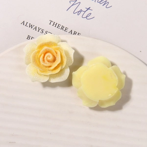 Macro detail of yellow resin rose charms with glitter for DIY hair accessories and crafts