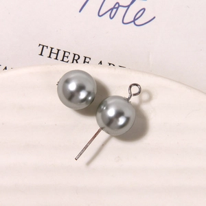 Macro detail of silver grey matte pearls with metal loop pins for DIY jewelry making