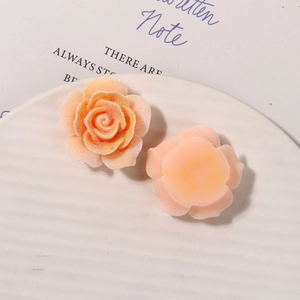 Detailed macro view of orange resin roses with sugary texture for DIY jewelry and crafts