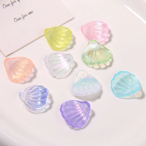 Macro shot of colorful shell-shaped acrylic beads with sparkling iridescent finish