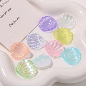 Macro detail of iridescent shell-shaped acrylic charms for DIY jewelry and crafts