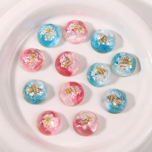 Macro detail of resin shoe charms with seashells, starfish and ocean gradient effects