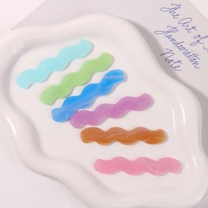 Colorful wave-shaped acrylic hair clips with marble texture in various pastel colors