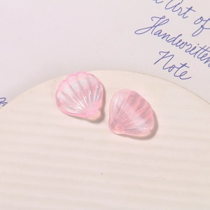 Macro detail of pink pearlescent shell accessories with fine silver glitter texture