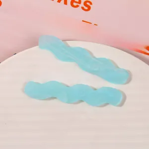Macro shot of two light blue wavy hair clips with subtle glitter finish on a white tray