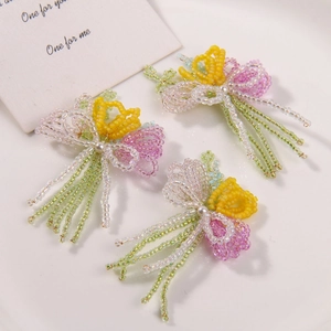 Close-up detail of handmade beaded tulip flowers in vibrant yellow and pink shades