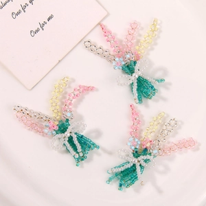 Detailed view of handmade beaded flower bouquets with pearl bow and colorful glass beads
