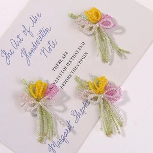 Detailed shot of handmade tulip floral beads with faux pearls and colorful seed beads